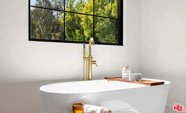 a bedroom with two beds and a window