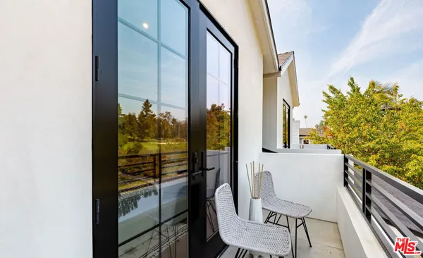 a room with lots of furniture and wooden floors