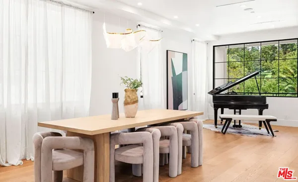 a kitchen with stainless steel appliances granite countertop a sink a stove and a wooden floor with outer view