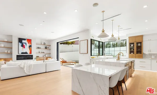 a large kitchen with stainless steel appliances kitchen island granite countertop a sink and cabinets