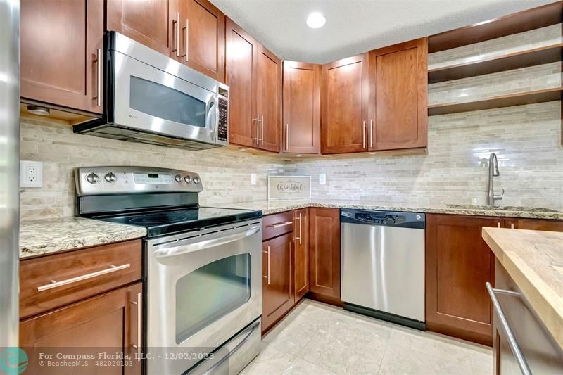 9268 Sable Ridge Circle, Unit C Boca Raton, FL 33428 - Photo 17 of 50 a kitchen with granite countertop a sink stainless steel appliances and cabinets