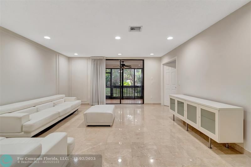 9268 Sable Ridge Circle, Unit C Boca Raton, FL 33428 - Photo 2 of 50 a spacious bedroom with a bed and a window
