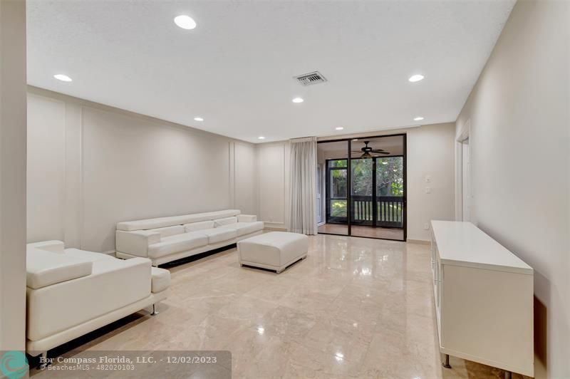 9268 Sable Ridge Circle, Unit C Boca Raton, FL 33428 - Photo 21 of 50 a spacious bedroom with a bed and a couch