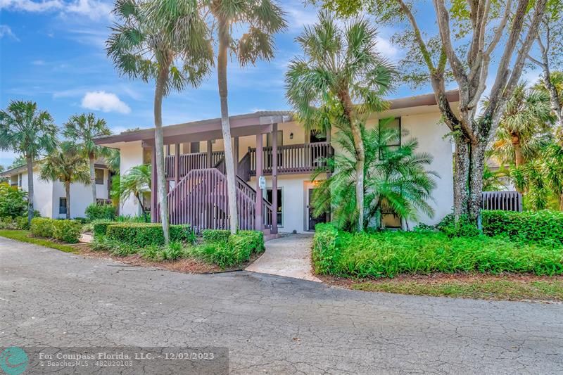 9268 Sable Ridge Circle, Unit C Boca Raton, FL 33428 - Photo 46 of 50 a front view of a house with garden and trees