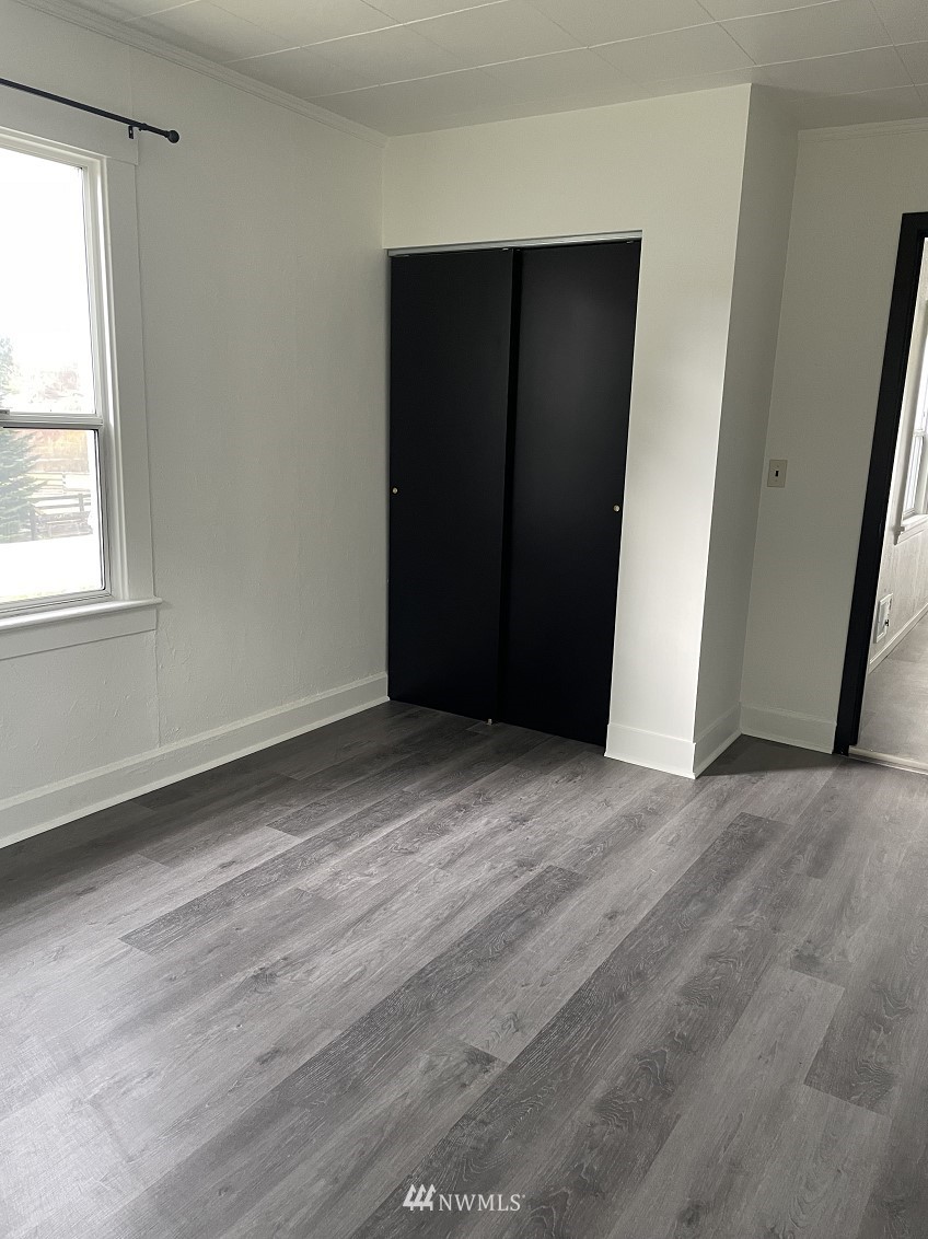 15346 Southeast May Valley Road Renton, WA 98059 - Photo 12 of 26 an empty room with wooden floor and closet
