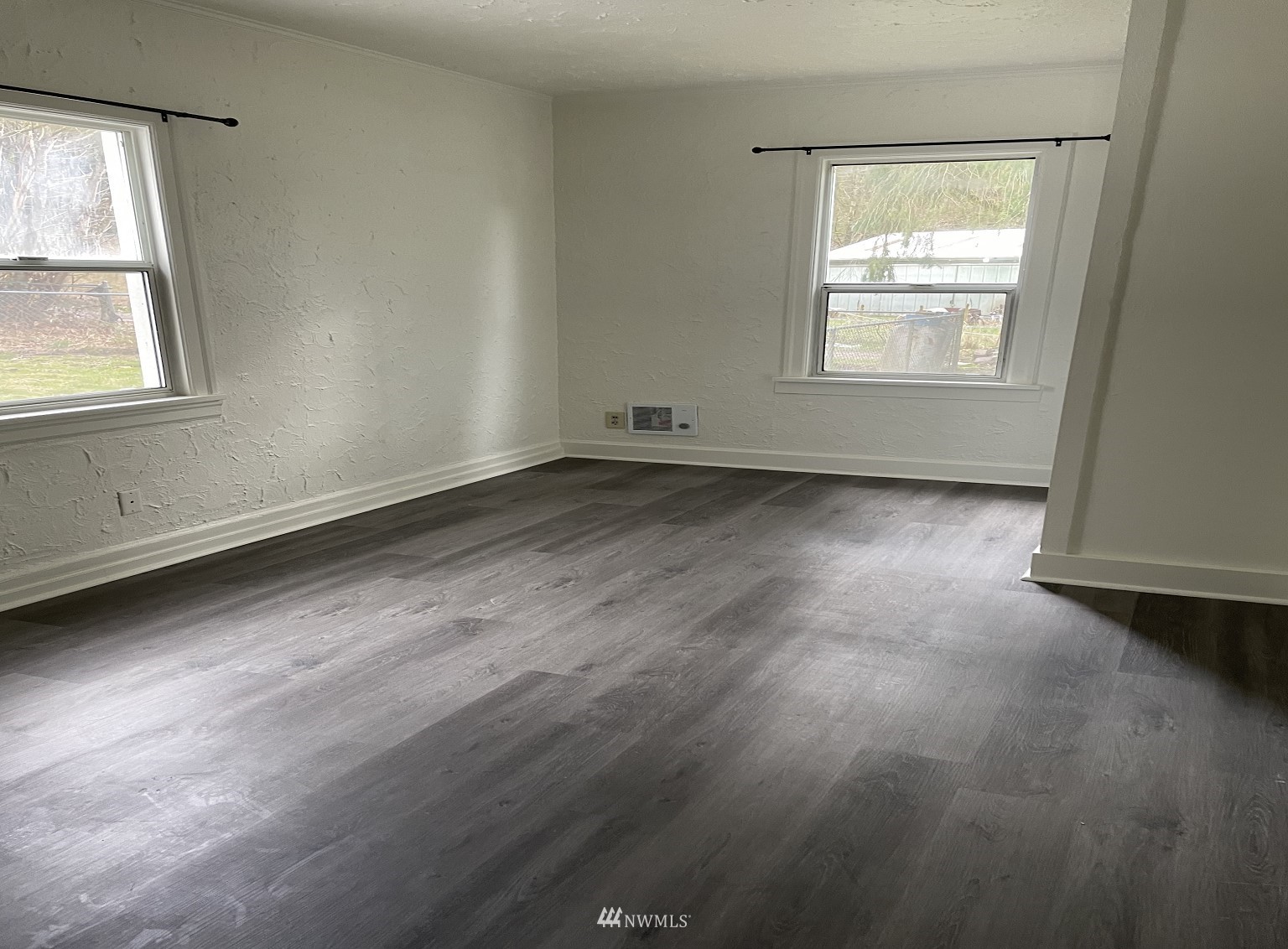 15346 Southeast May Valley Road Renton, WA 98059 - Photo 17 of 26 an empty room with wooden floor and windows