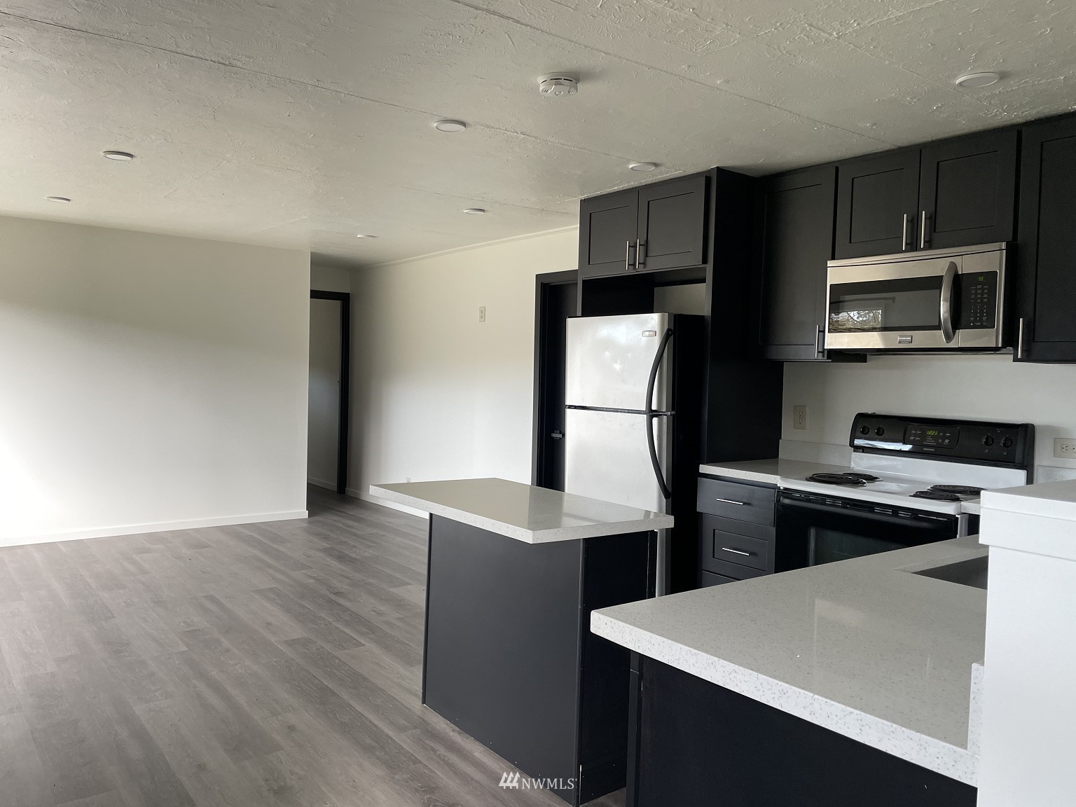 15346 Southeast May Valley Road Renton, WA 98059 - Photo 7 of 26 a kitchen with cabinets and stainless steel appliances