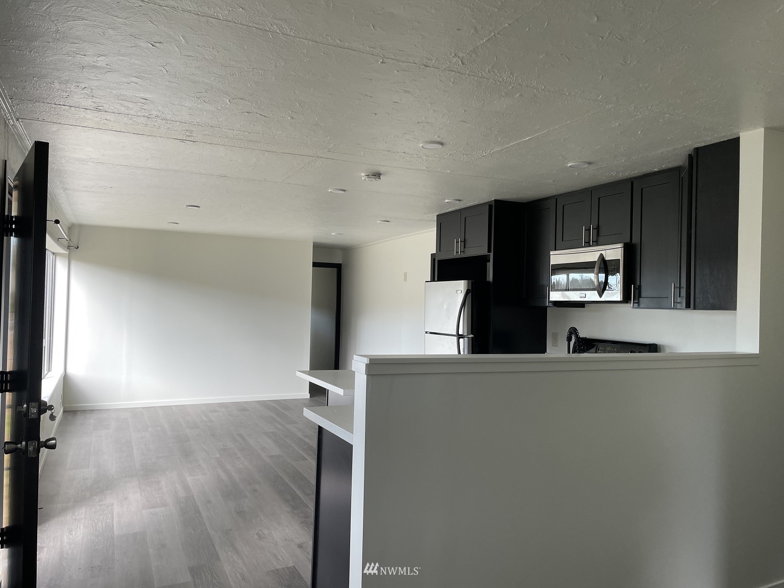 15346 Southeast May Valley Road Renton, WA 98059 - Photo 8 of 26 a kitchen with kitchen island a refrigerator and a stove top oven
