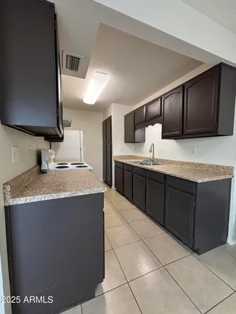 a kitchen with a sink a counter top space and cabinets