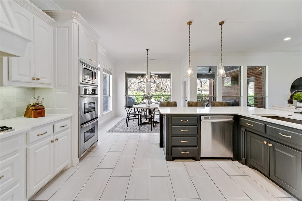 15 Falcons View Pass Heath, TX 75032 - Photo 12 of 38 a kitchen with stainless steel appliances kitchen island granite countertop a stove a sink and a cabinets