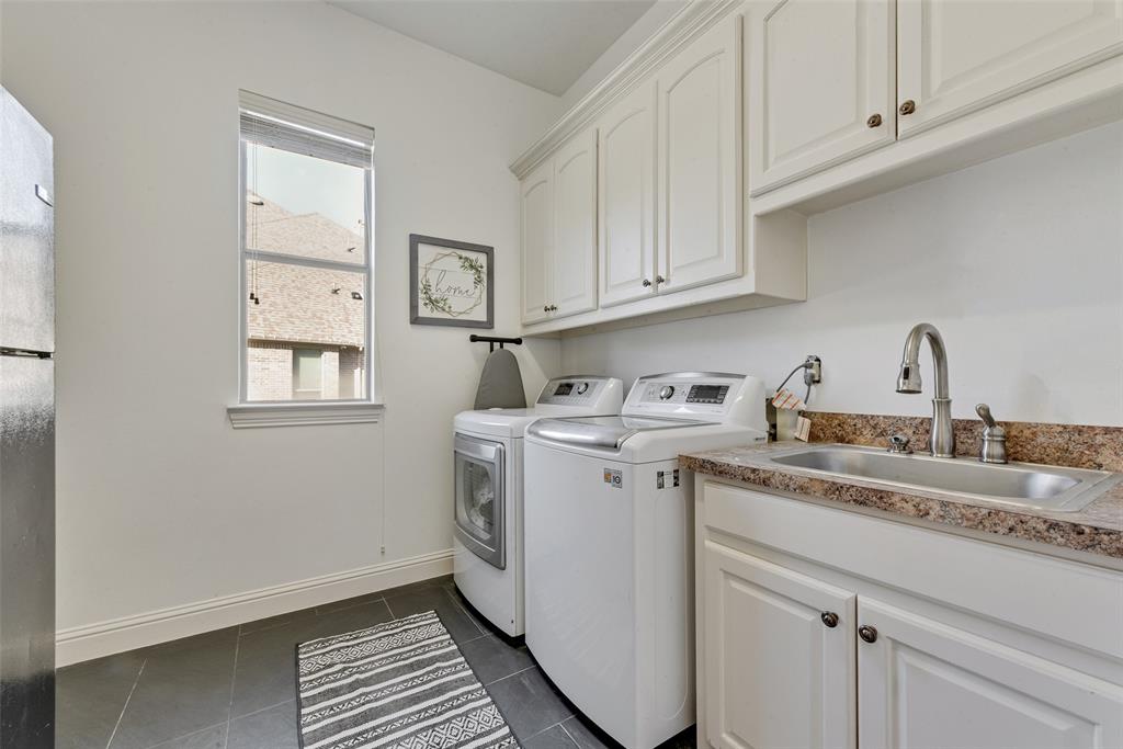 15 Falcons View Pass Heath, TX 75032 - Photo 14 of 38 a utility room with sink dryer and cabinets