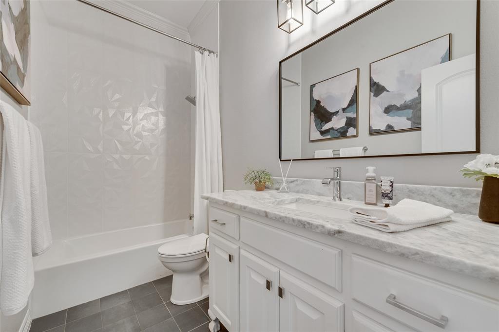 15 Falcons View Pass Heath, TX 75032 - Photo 19 of 38 a bathroom with a granite countertop sink a toilet and a bathtub