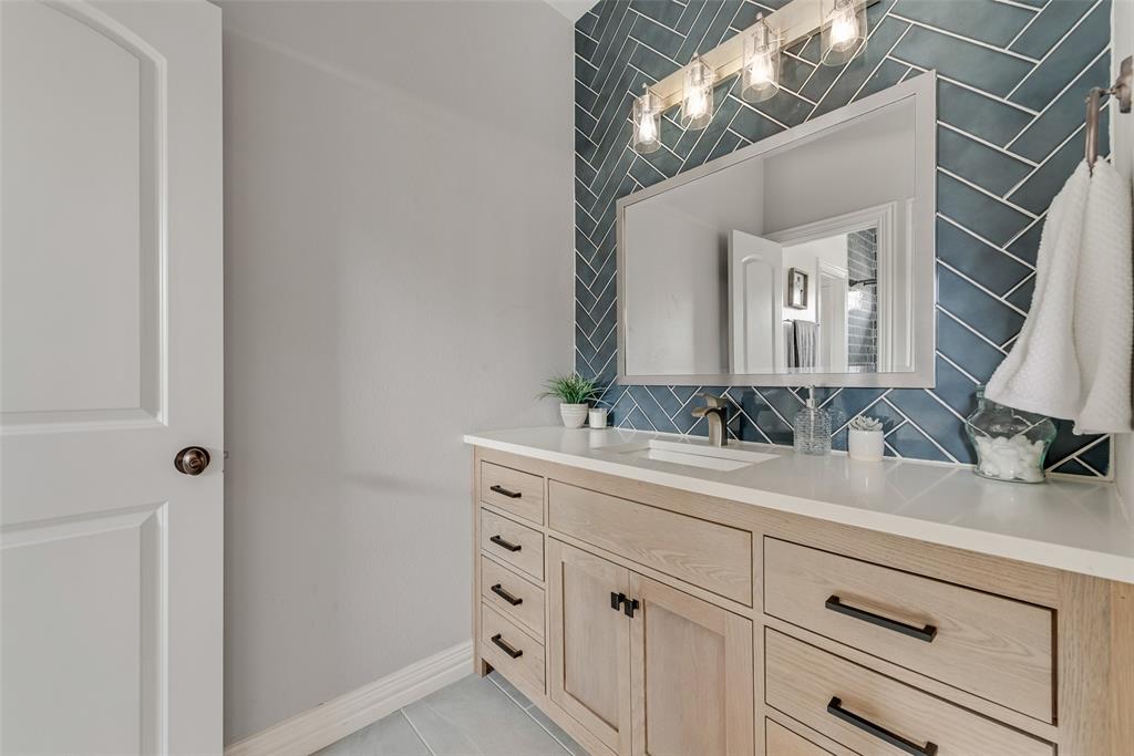 15 Falcons View Pass Heath, TX 75032 - Photo 28 of 38 a bathroom with a sink and a mirror