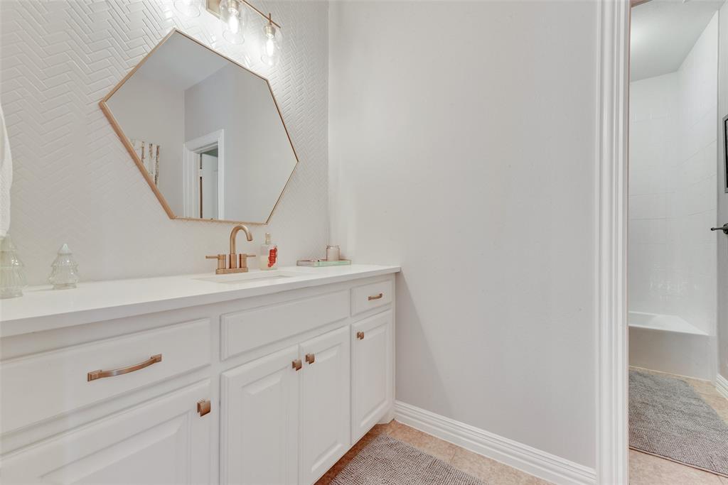 15 Falcons View Pass Heath, TX 75032 - Photo 30 of 38 a bathroom with a sink and a mirror