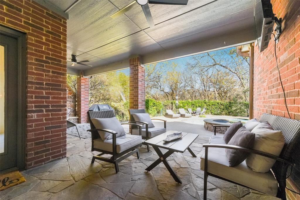 15 Falcons View Pass Heath, TX 75032 - Photo 32 of 38 a living room with couches and a dining table with garden view