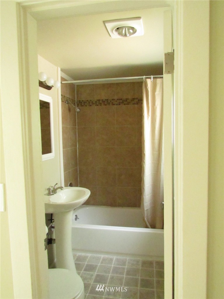 100 Northwest 3rd Place Renton, WA 98057 - Photo 13 of 18 a bathroom with a sink a toilet and shower