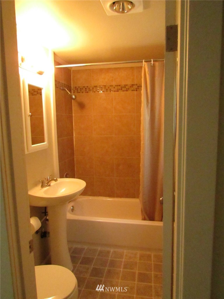 100 Northwest 3rd Place Renton, WA 98057 - Photo 14 of 18 a bathroom with a sink toilet and shower