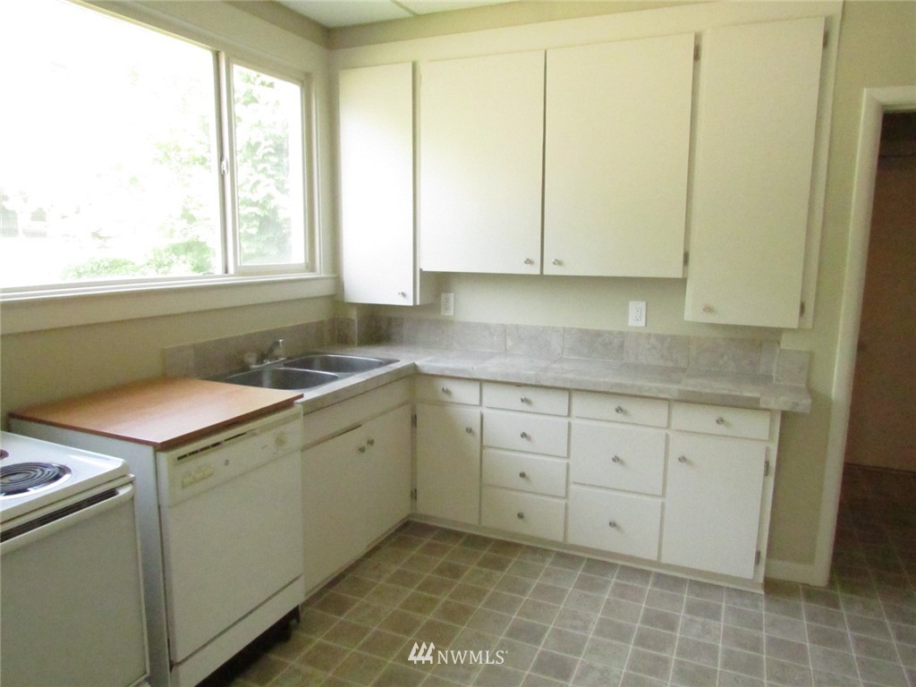100 Northwest 3rd Place Renton, WA 98057 - Photo 16 of 18 a kitchen with a sink cabinets and window