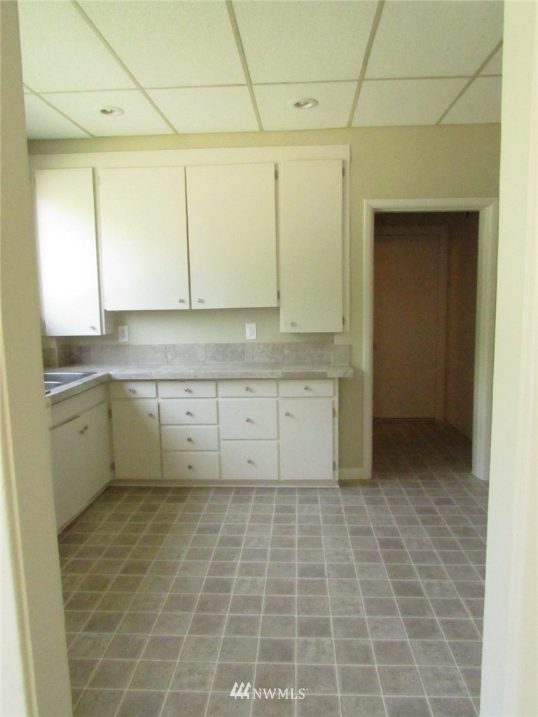 100 Northwest 3rd Place Renton, WA 98057 - Photo 17 of 18 a view of a kitchen with white cabinets