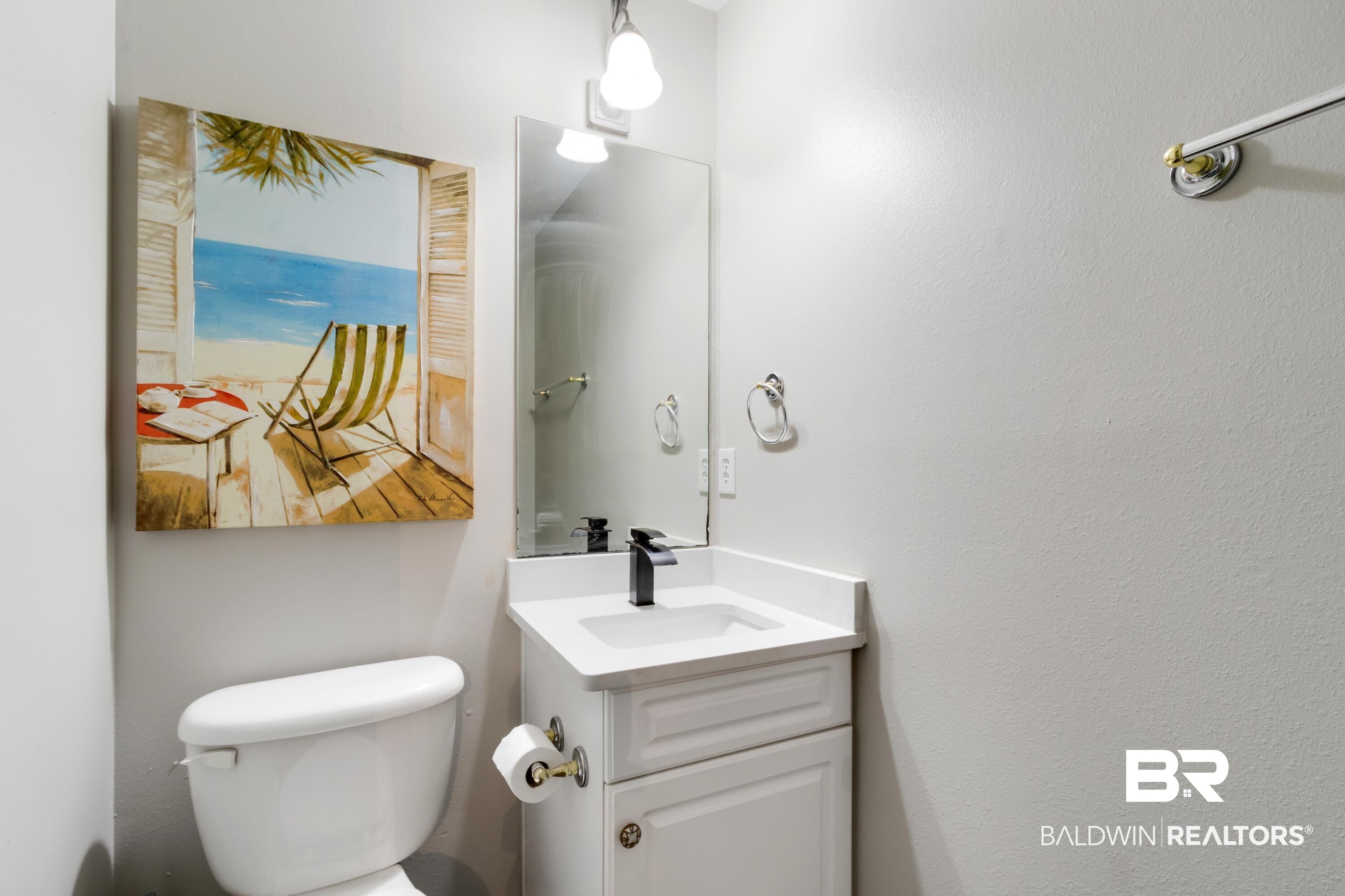 25957 Canal Road, Unit 208 Orange Beach, AL 36561 - Photo 19 of 28 White vanity with a single basin sink and black faucet