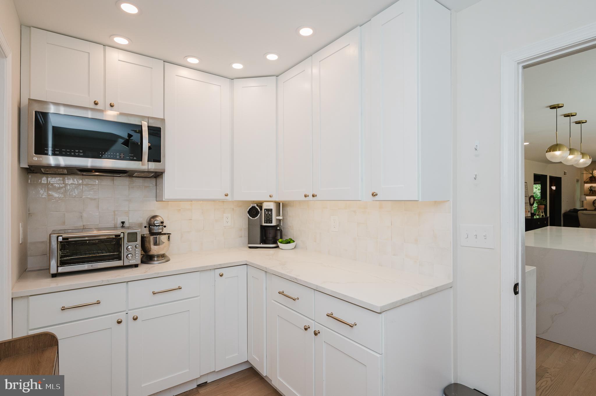 2056 Chapel Road Havre de Grace, MD 21078 - Photo 41 of 120 a kitchen with white cabinets stainless steel appliances and sink