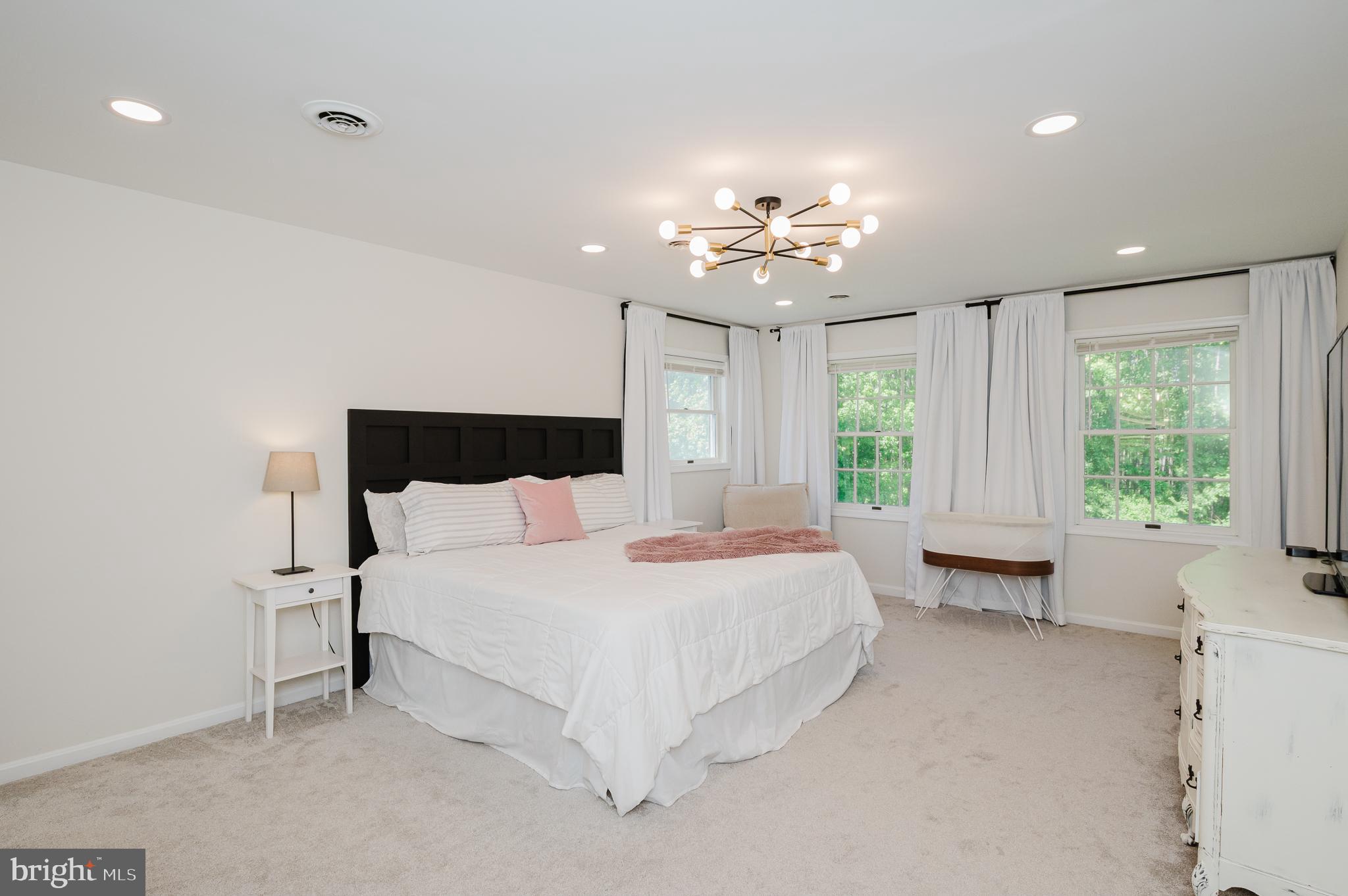 2056 Chapel Road Havre de Grace, MD 21078 - Photo 47 of 120 a spacious bedroom with a large bed and a chandelier