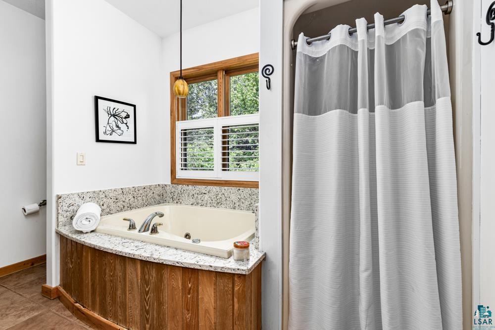 4471 South Rockmont Road South Range, WI 54874 - Photo 26 of 48 Bathroom featuring tile floors and a bathing tub