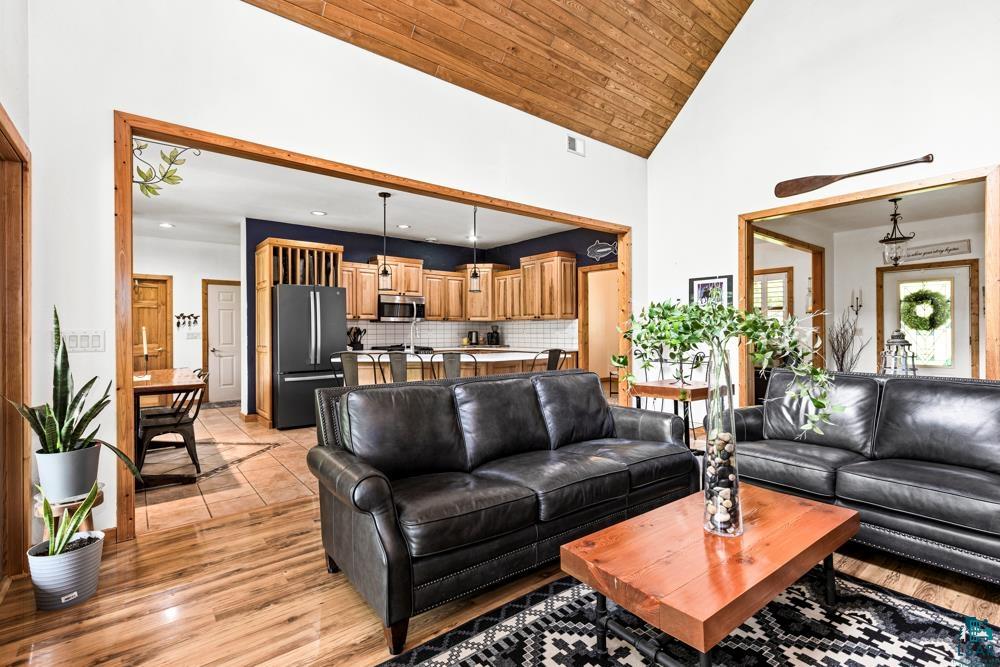 4471 South Rockmont Road South Range, WI 54874 - Photo 9 of 48 Living room featuring high vaulted ceiling, light hardwood / wood-style flooring, and wooden ceiling