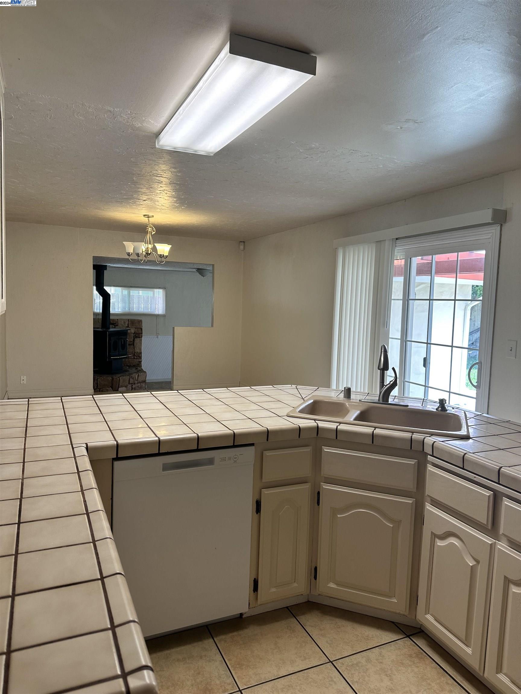 Carlton Square Livermore, CA 94550 - Photo 12 of 25 a kitchen with a sink and cabinets
