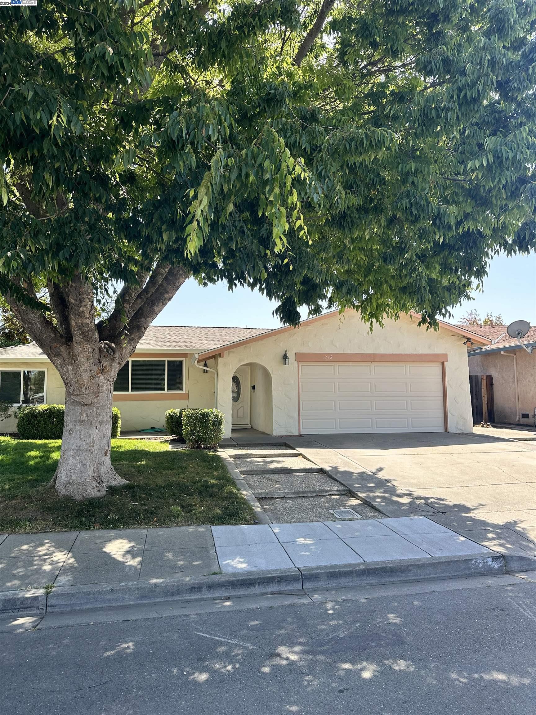 Carlton Square Livermore, CA 94550 - Photo 2 of 25 a front view of a house with a yard and garage
