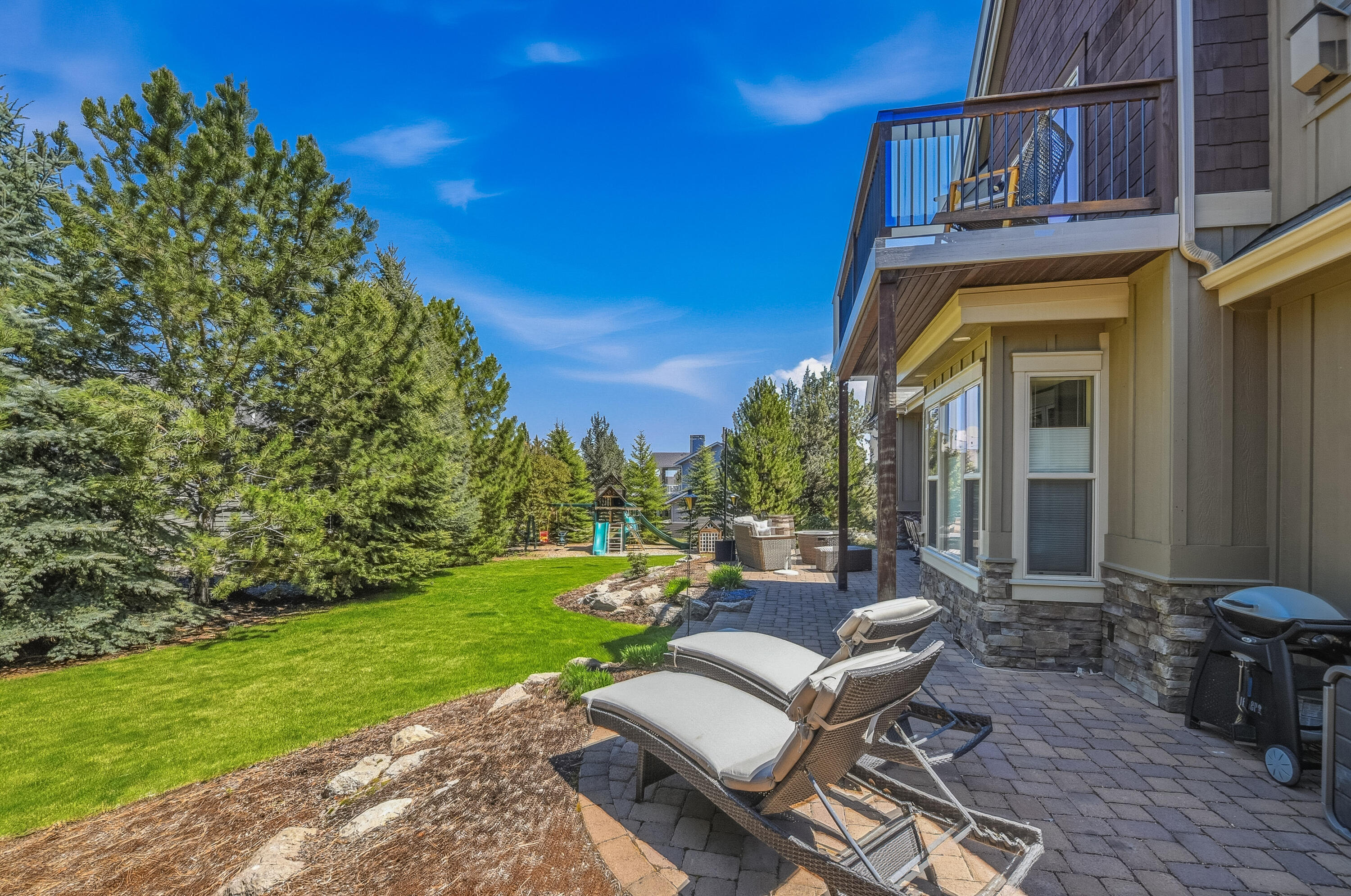 9009 Merlin Drive Redmond, OR 97756 - Photo 76 of 98 a view of a patio with couches table and chairs and potted plants