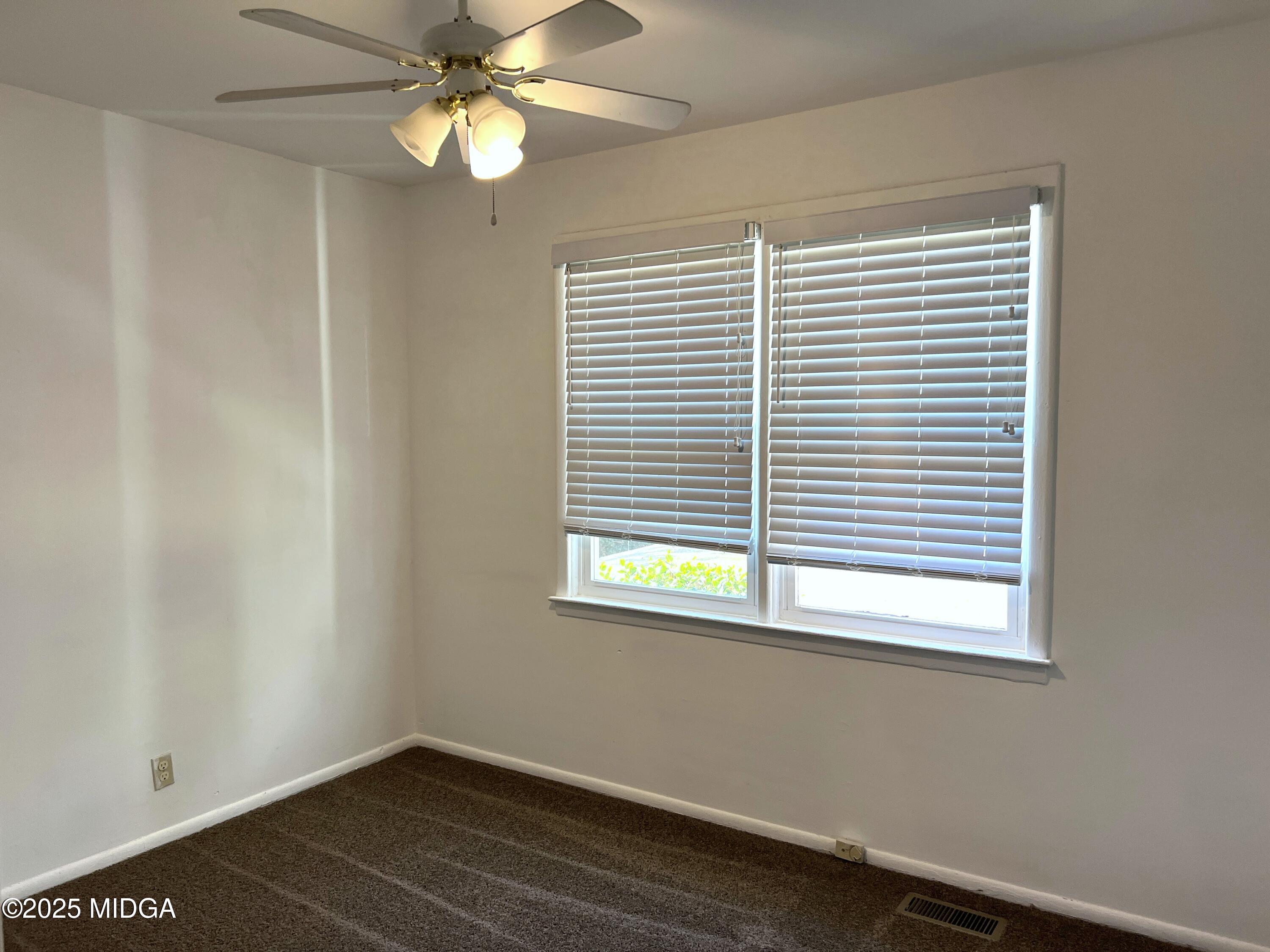 3347 Thunderbird Road Macon, GA 31217 - Photo 13 of 27 a view of an empty room with a window and wooden floor