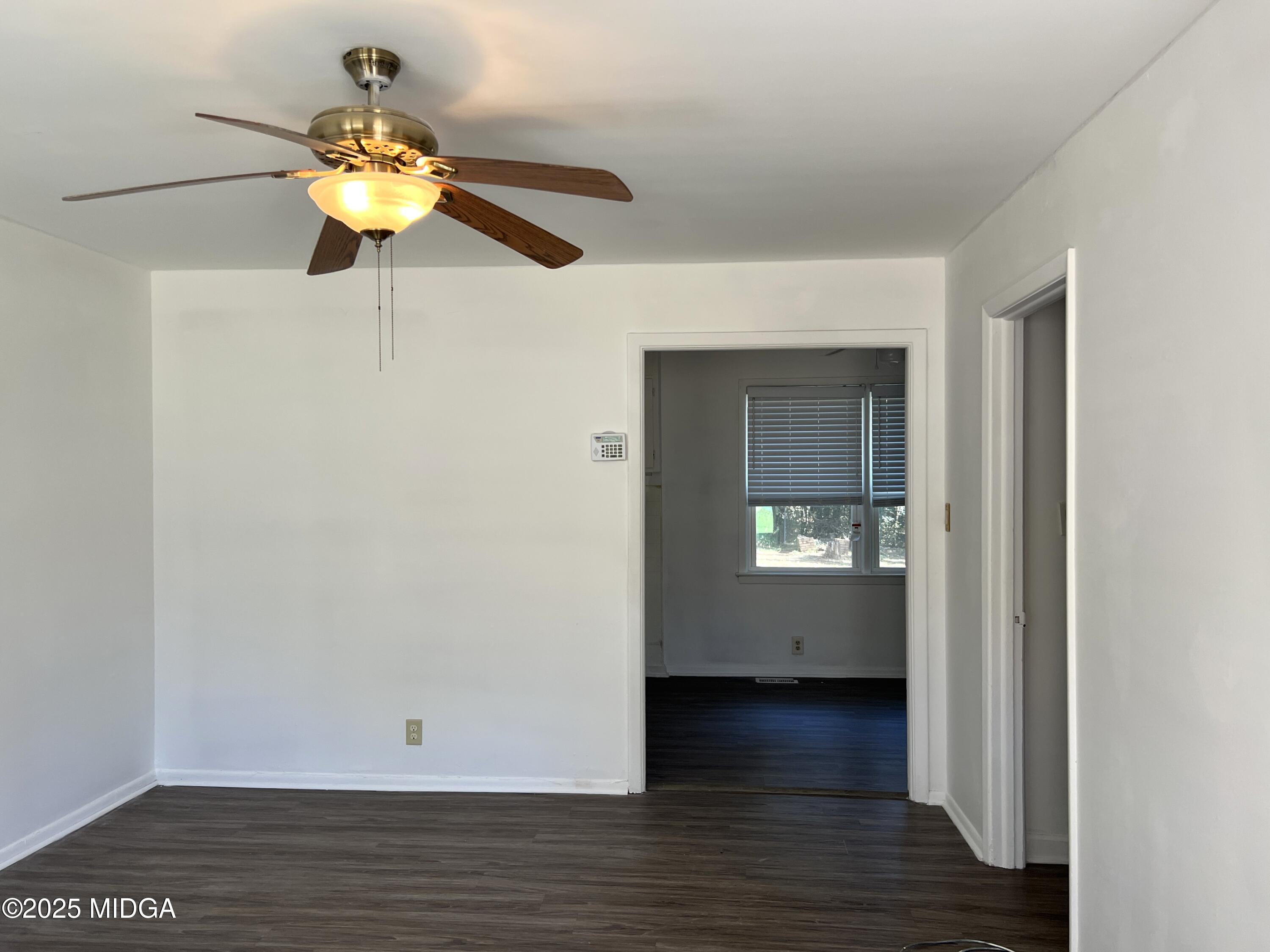 3347 Thunderbird Road Macon, GA 31217 - Photo 3 of 27 a view of an empty room with wooden floor and a window