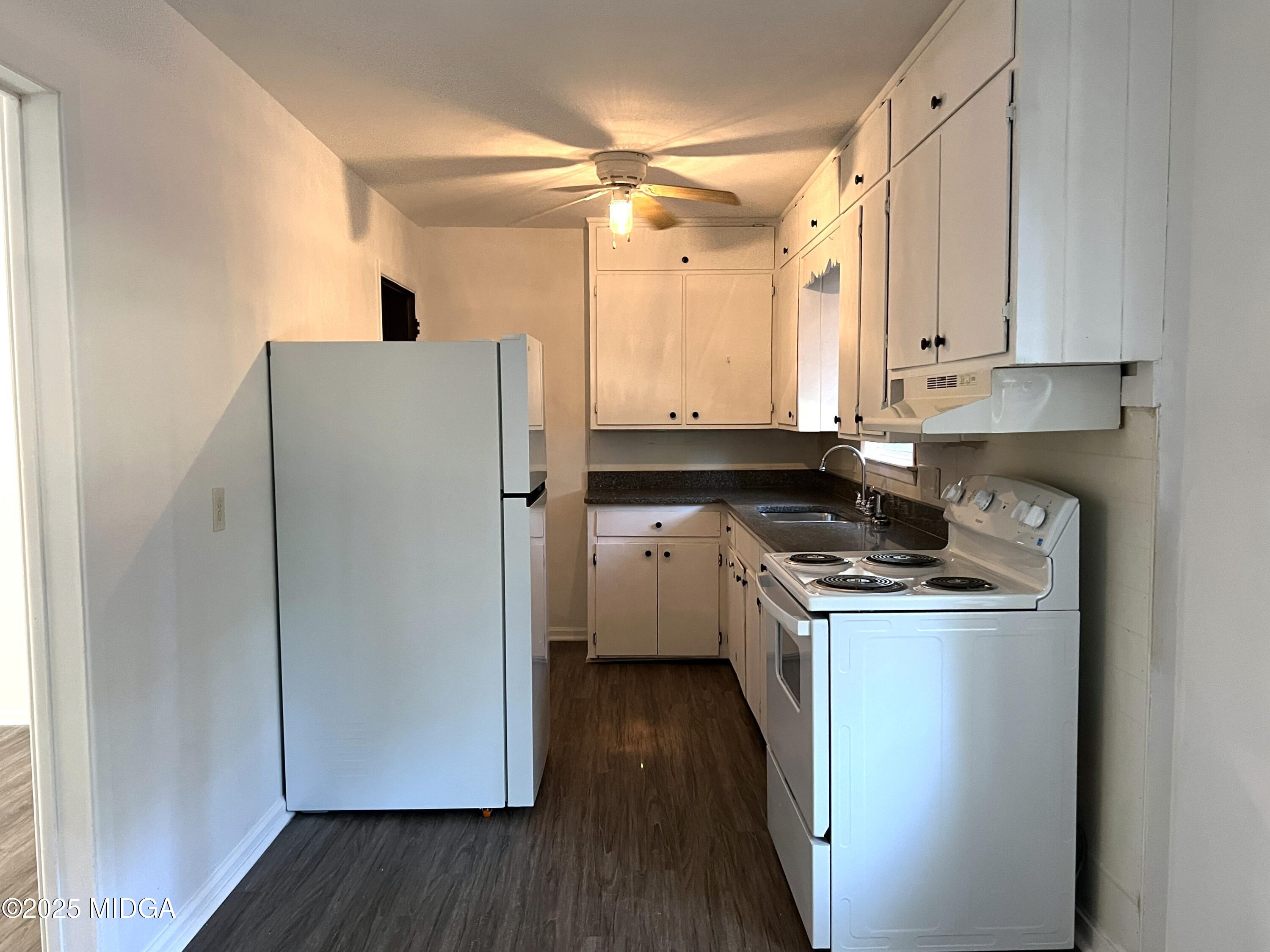 3347 Thunderbird Road Macon, GA 31217 - Photo 7 of 27 a kitchen with a refrigerator a sink and wooden floor