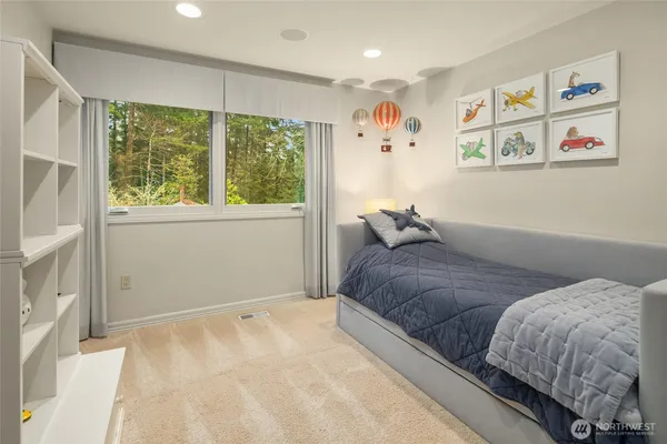 a bedroom with a large bed and a lamp