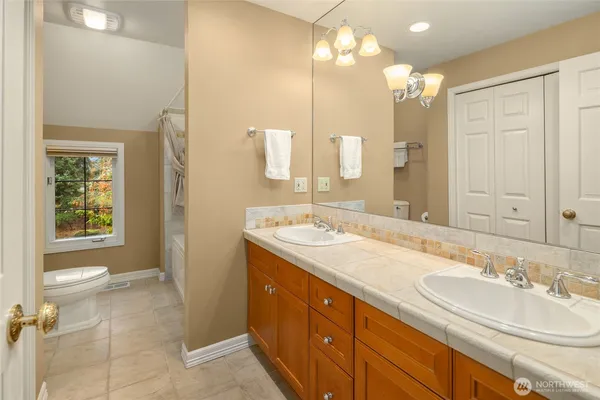 a bathroom with a shower sink and mirror
