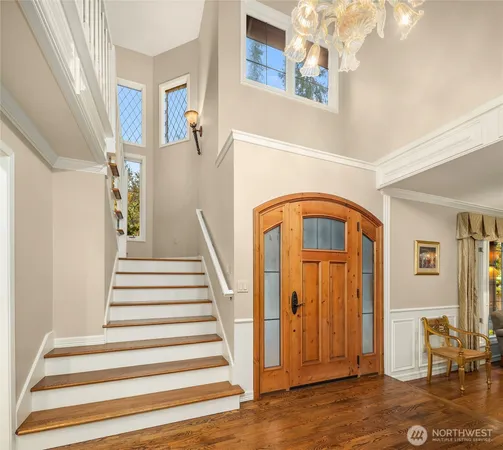 a view of entryway and hall with wooden floor