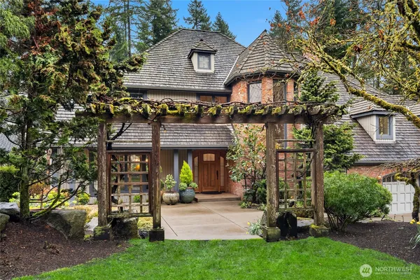 an aerial view of a house with garden space and street view