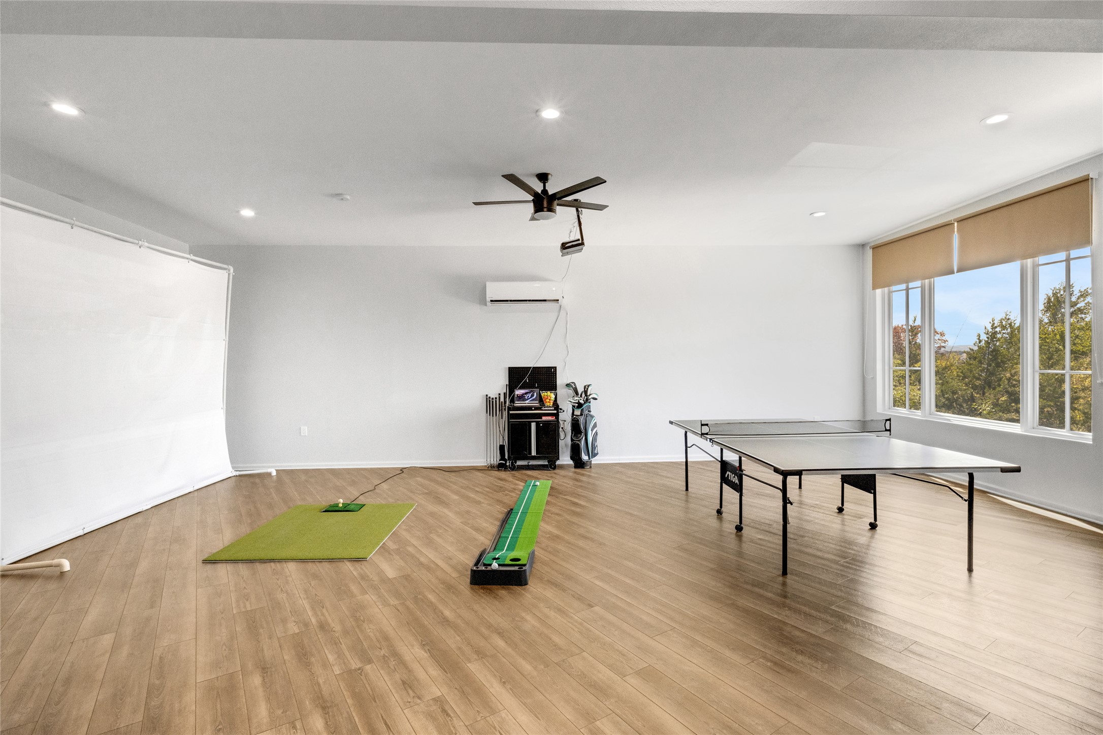 4227 Eck Lane Austin, TX 78734 - Photo 25 of 30 Game room with wood finished floors, a ceiling fan, recessed lighting, and a wall mounted air conditioner