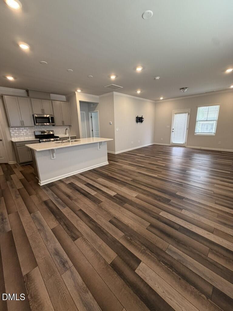 2509 Salt River Lane Raleigh, NC 27616 - Photo 5 of 34 a large white kitchen with kitchen island a sink stainless steel appliances and cabinets