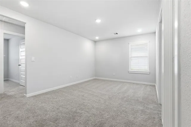 an empty room with windows and closet
