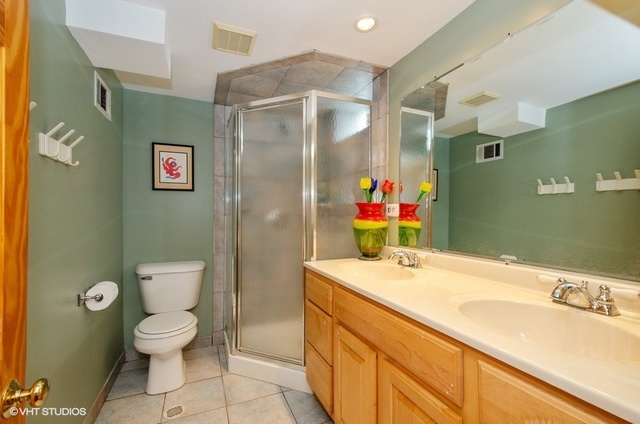 1025 Kent Avenue Park Ridge, IL 60068 - Photo 22 of 27 a bathroom with a sink mirror vanity and toilet