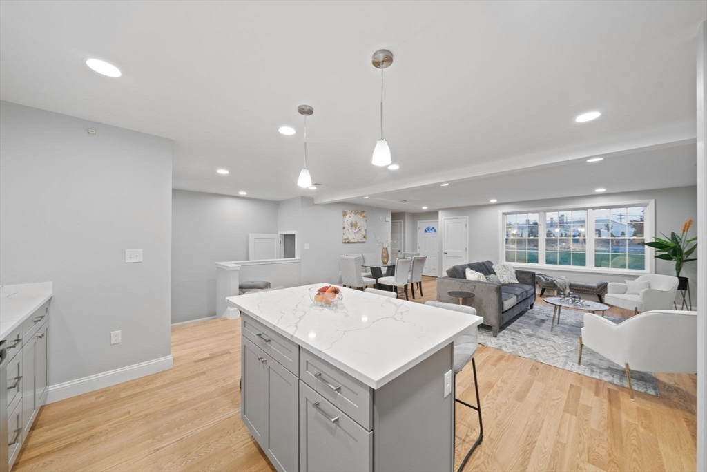 14 Simmonds Boulevard, Unit 14 Randolph, MA 02368 - Photo 5 of 30 a view of a kitchen with kitchen island a sink a counter top space and living room view