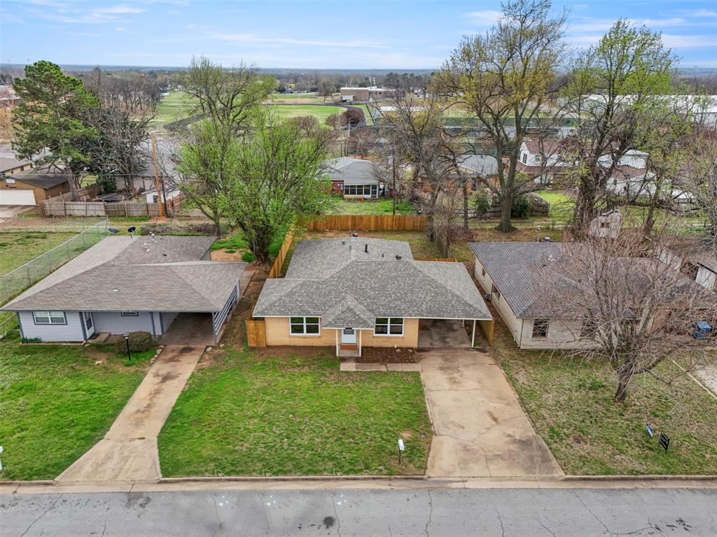 732 Bullock Street Denison, TX 75020 - Photo 25 of 29 an aerial view of a house with swimming pool and garden