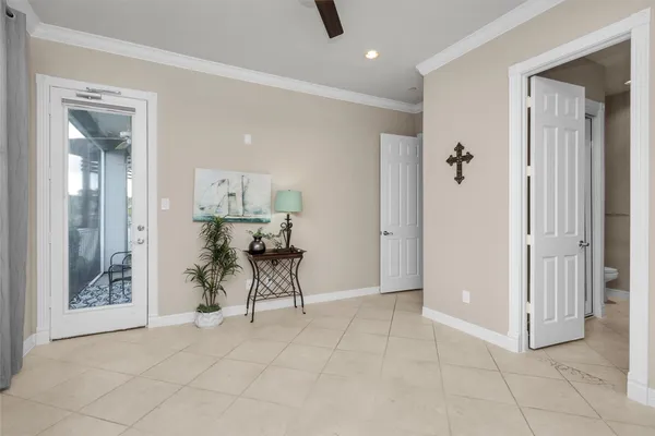 a bedroom with a bed and a flat tv screen on dresser