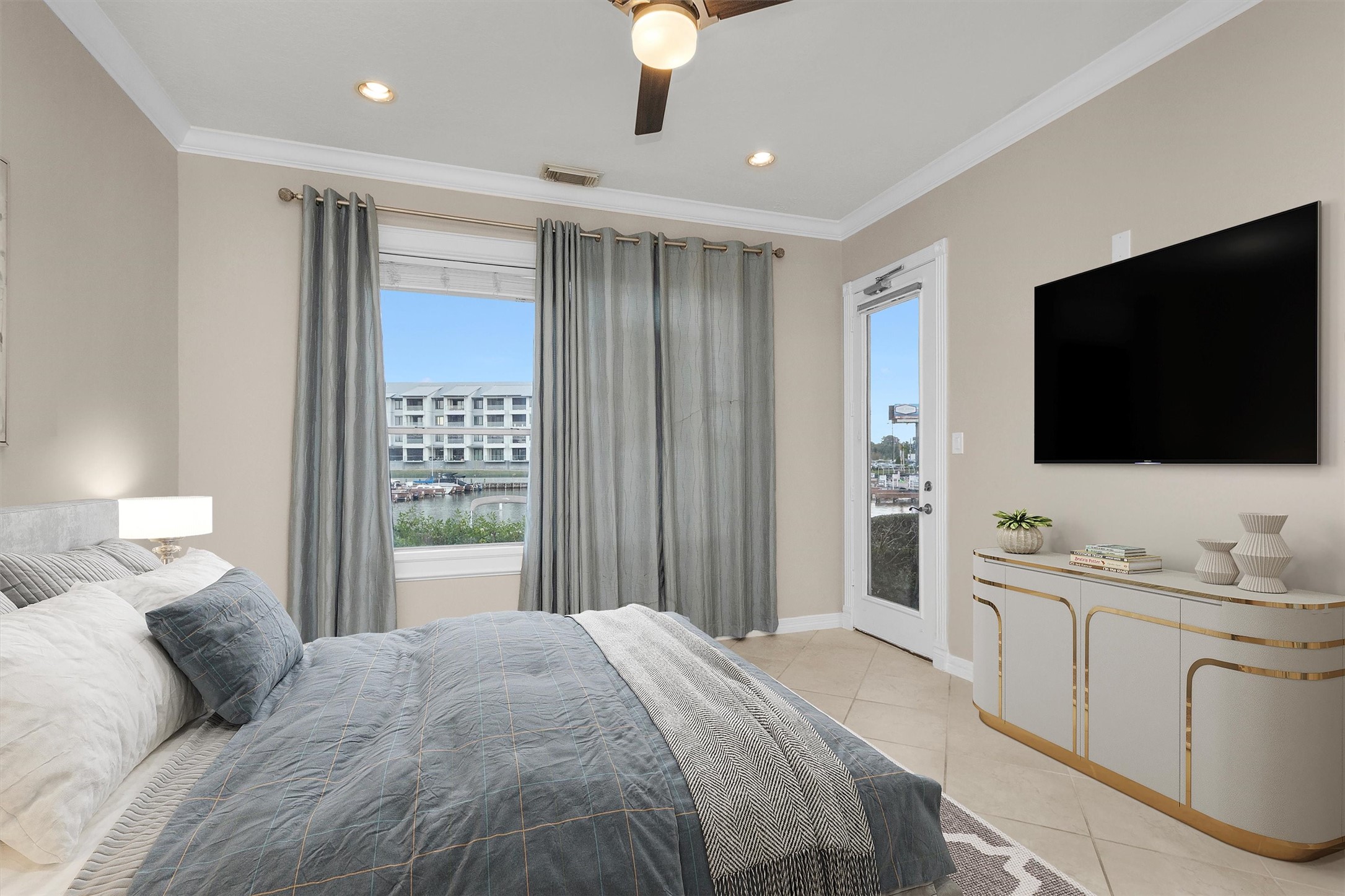 168 Lake Point Boulevard Montgomery, TX 77356 - Photo 18 of 34 a bedroom with a bed and a flat tv screen on dresser