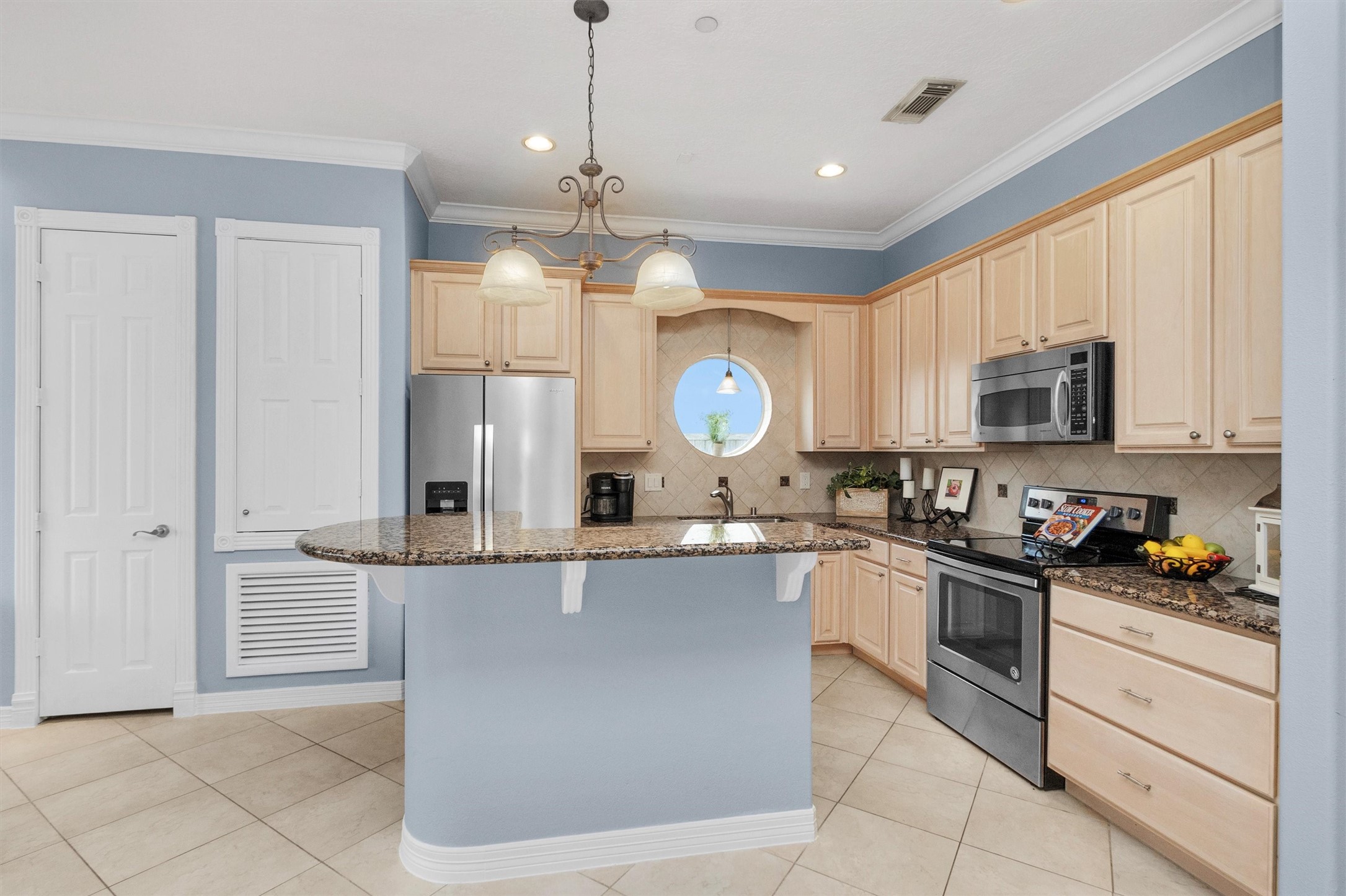 168 Lake Point Boulevard Montgomery, TX 77356 - Photo 31 of 34 a kitchen with stainless steel appliances granite countertop a sink a stove top oven a counter space and cabinets
