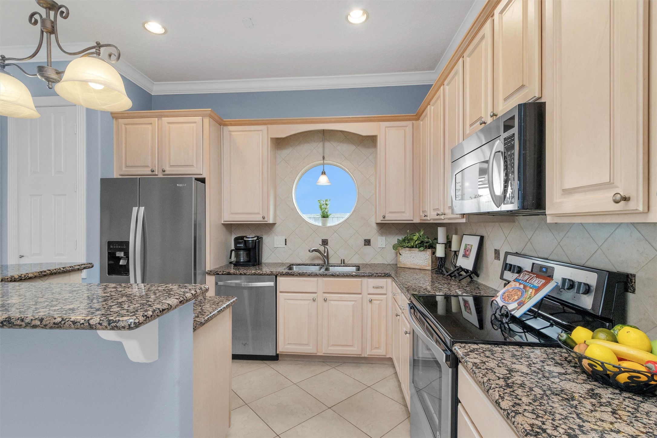 168 Lake Point Boulevard Montgomery, TX 77356 - Photo 32 of 34 a kitchen with stainless steel appliances granite countertop a sink stove and refrigerator