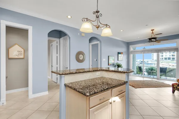 a view of a kitchen with a stove and a chandelier