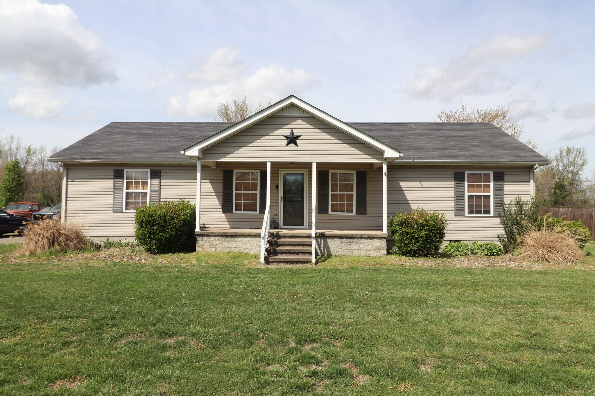 353 Stevens Circle Lafayette, TN 37083 - Photo 23 of 25 a front view of a house with a yard and garage
